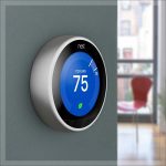 A smart thermostat on the wall at 75 degrees