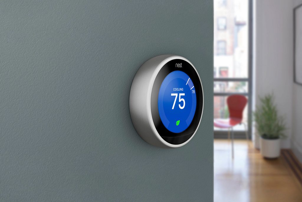 Nest thermostat on a wall that says cooling 75