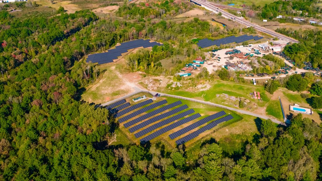 An aerial view of three community solar fields