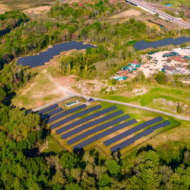 An aerial view of three community solar fields