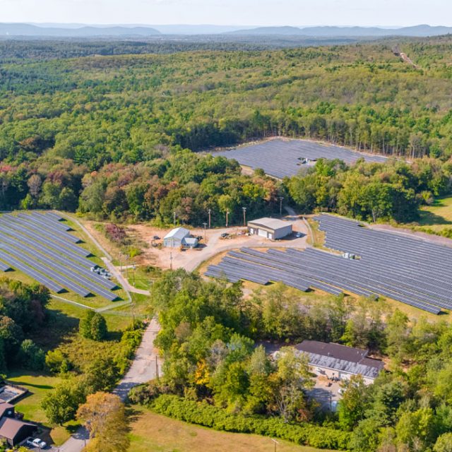 An aerial view of three community solar gardens in Massachusetts