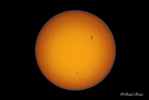 Dark sunspots on the surface of the sun.
