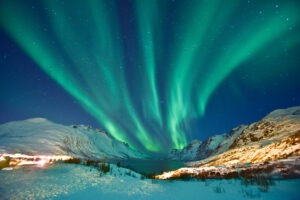 Aurora Borealis lighting up the night sky during the winter season in Norway.