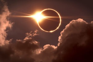 The moon covering the sun during a total solar eclipse.