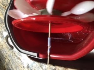 close view of water wheel experiment showing string on dowel