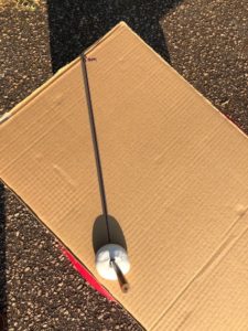 marking the time on cardboard sundial at 8am