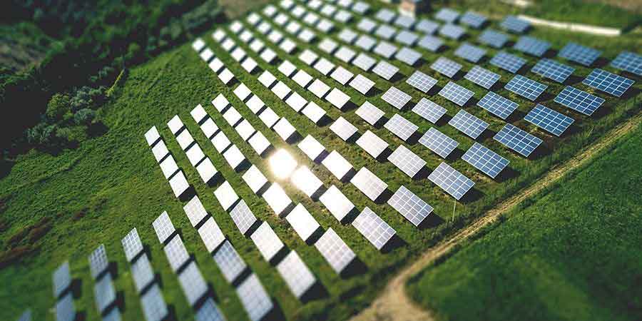 bird's eye view of solar farm in green field