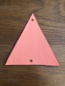 cut paper triangle with two hole punches