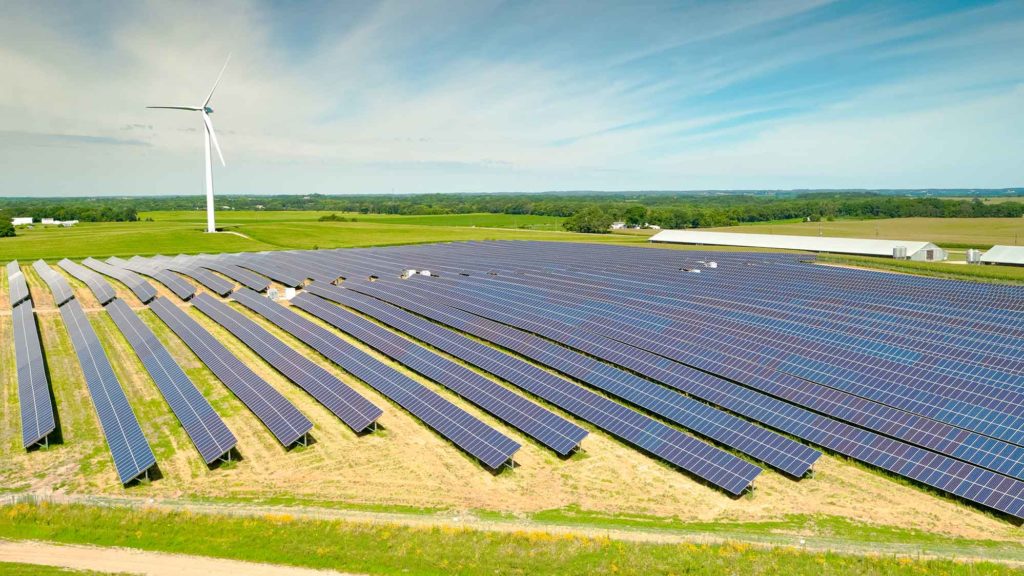 Rows of solar panels in a solar farm field