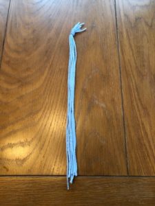 nine pieces of blue string tied together with a knot at the top