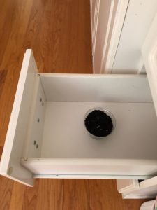 plastic cup of soil in drawer