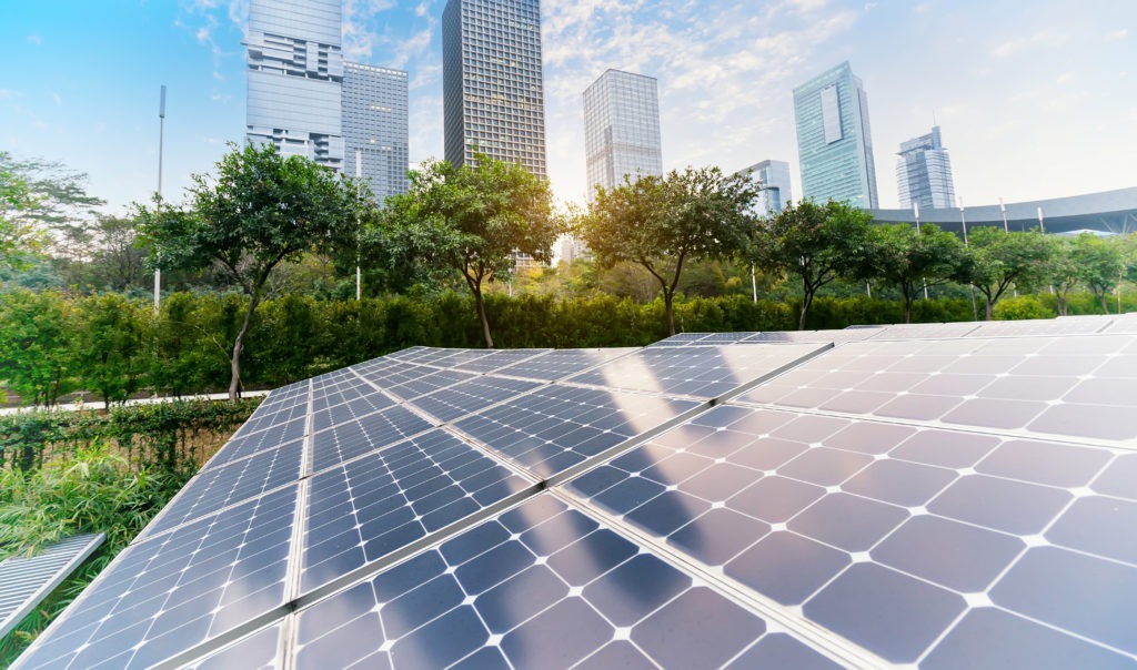 Solar panels with city in the background