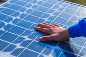 Child touching a solar panel