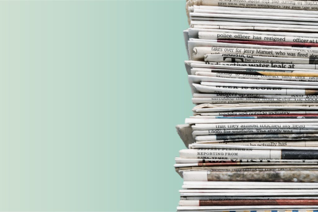stack of newspapers with green background