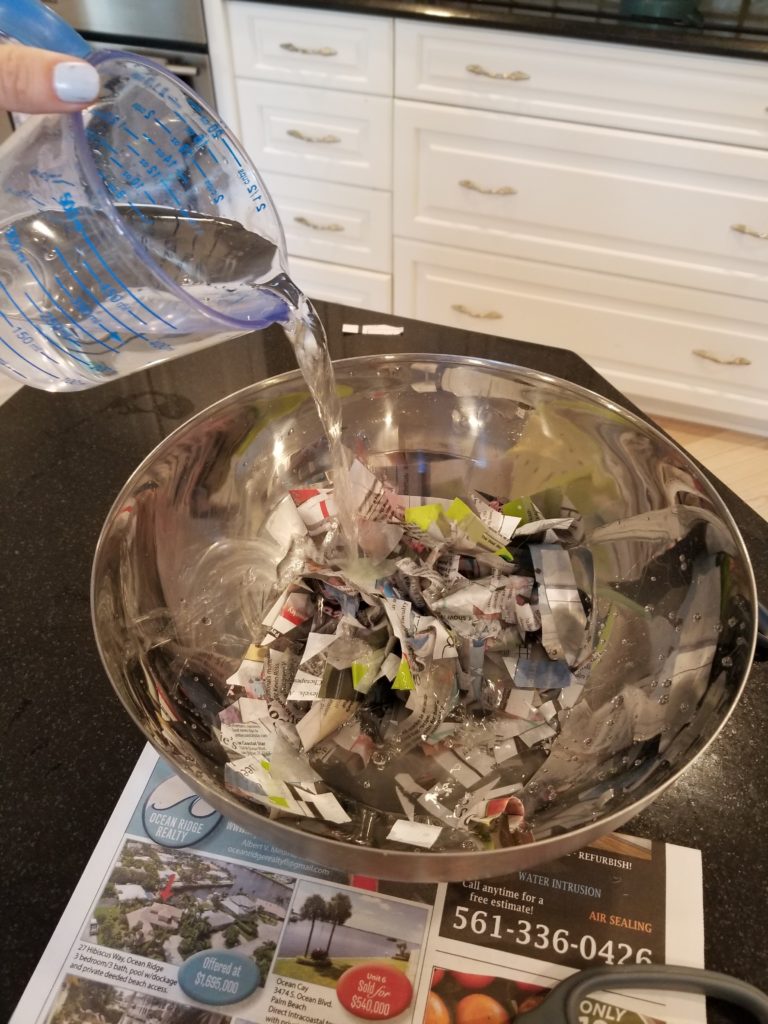 pouring water on cut paper in a bowl