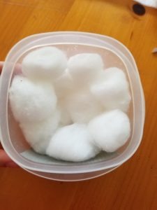 A container with cotton balls inside