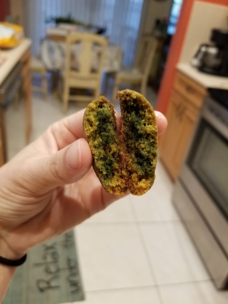 A person splitting a cookie in half for our SunButter Cookie Chemical Reaction Experiment