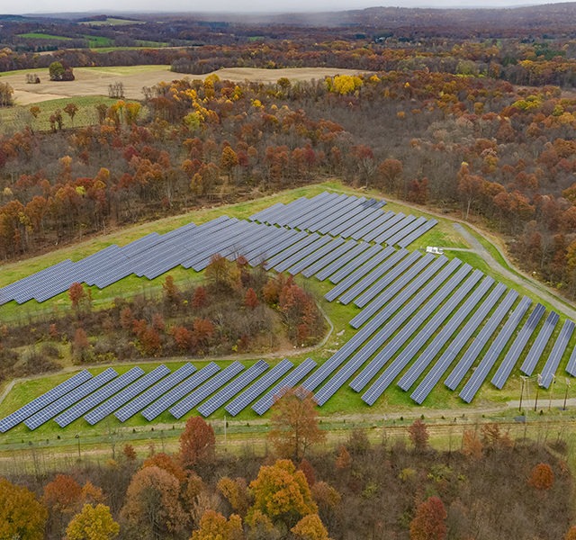 Aerial view of solar panels in a solar farm field