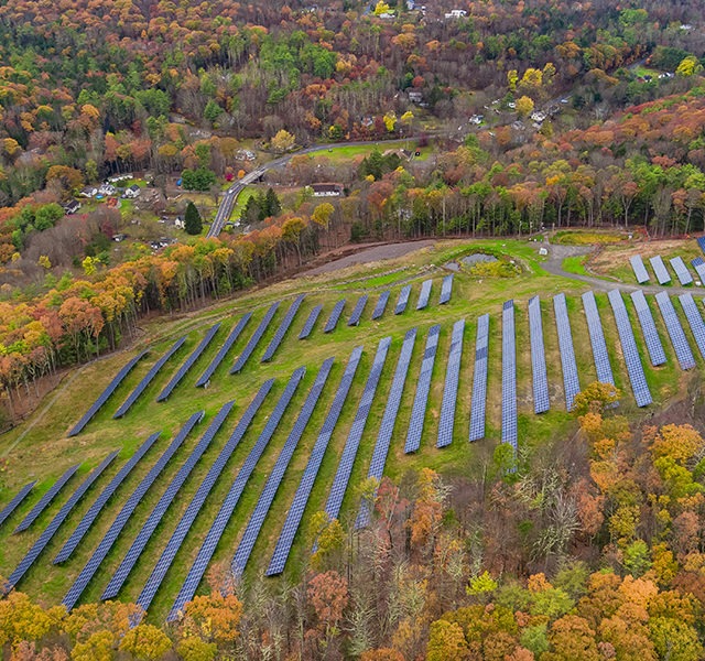 Aerial view of solar panels in a solar farm field
