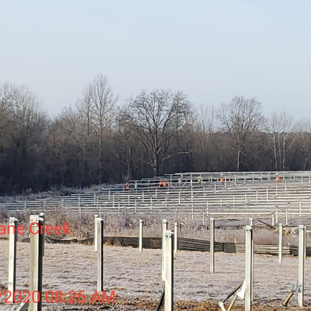 field full of solar farm equipment