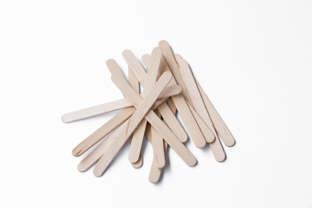 Wooden popsicle sticks on white background