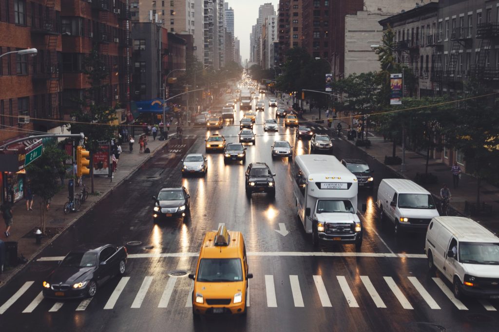 Fossil fuels being released through cars in big city traffic.