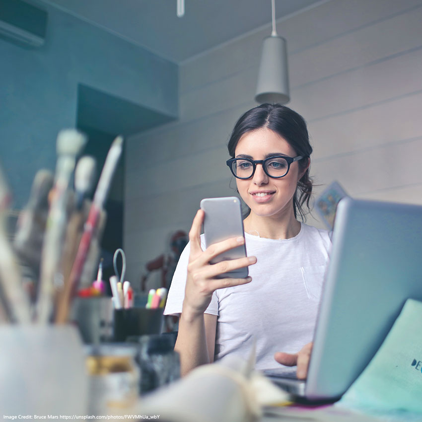 Woman turning off their lights using the app on her phone to save energy